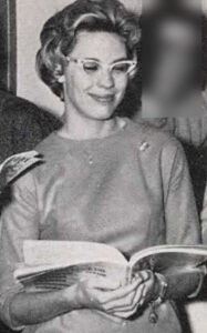 black-white photo of blond wearing glasses