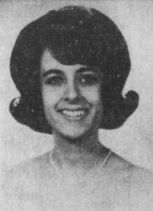 Dark-haired girl wearing a flip hairstyle in 1964. 