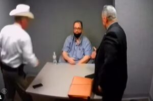 Three men in an interview room.