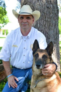 man with cowboy hat and dog