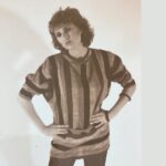female full body in striped shirt leaning over