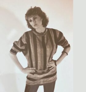 female full body in striped shirt leaning over