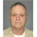 man in tan cjumpsuit headshot