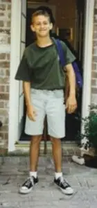 photo of 12 year old boy in green shirt and denim shorts